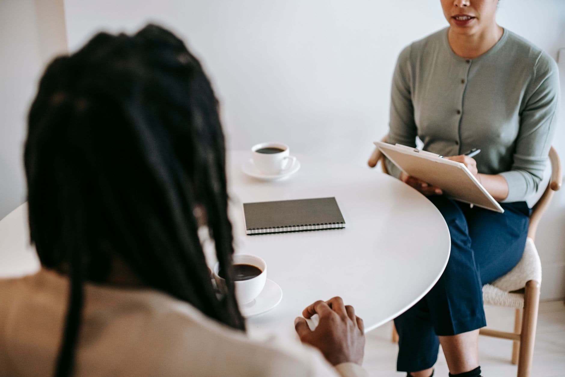 A parent talking with a therapist across a table