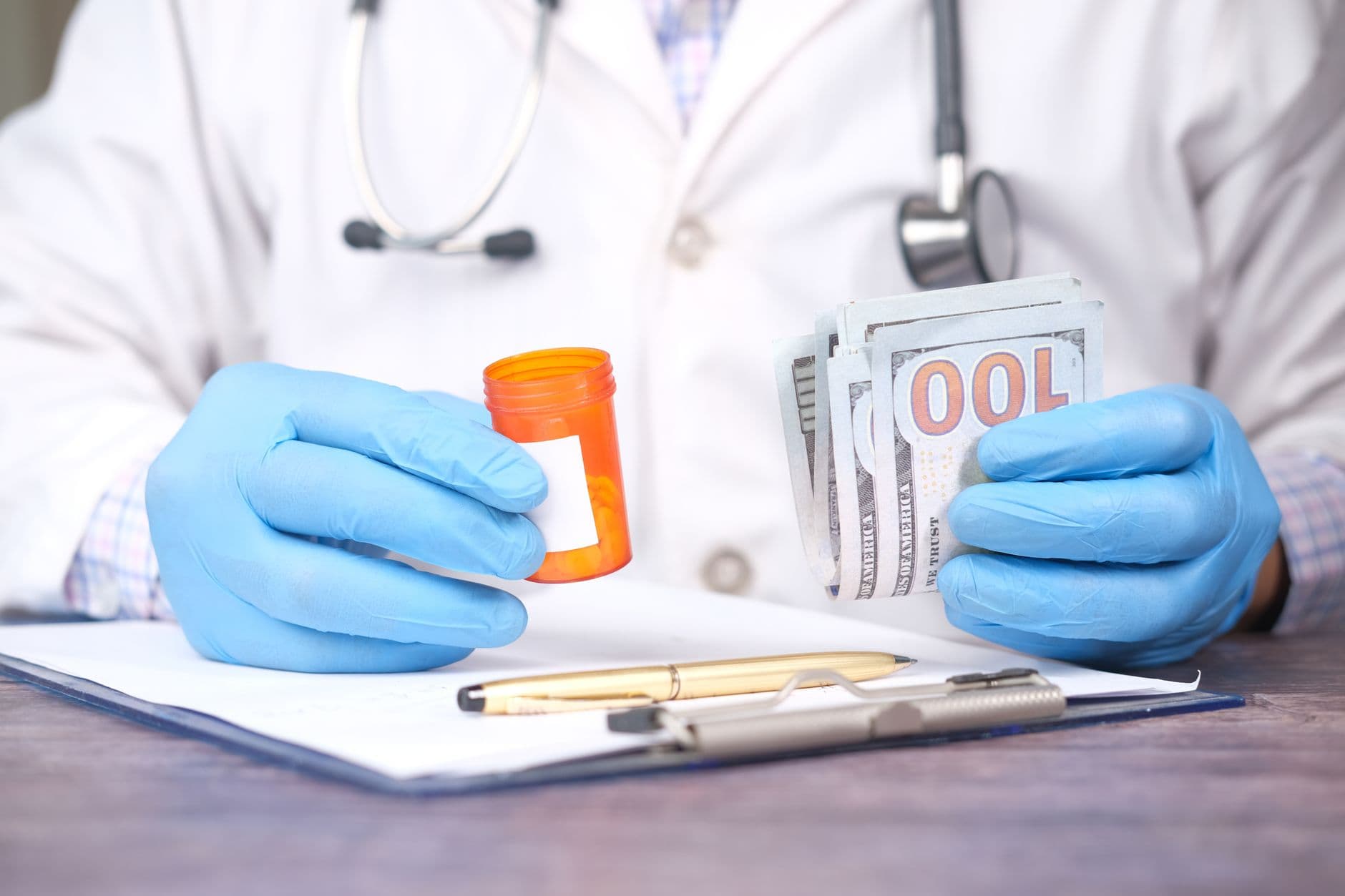 A person holding a health insurance card at a desk