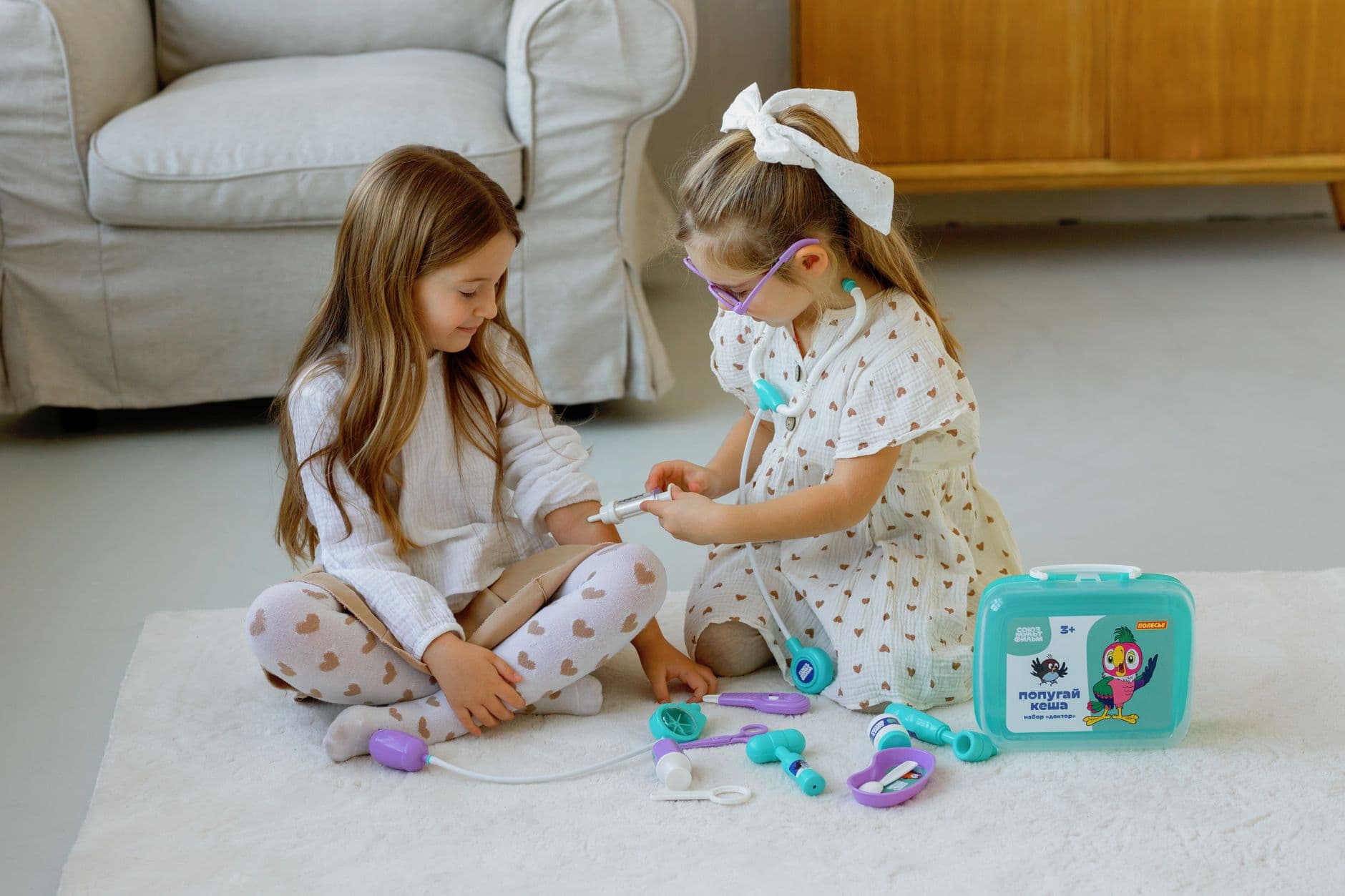 A pediatrician observing a toddler playing with toys during a developmental check