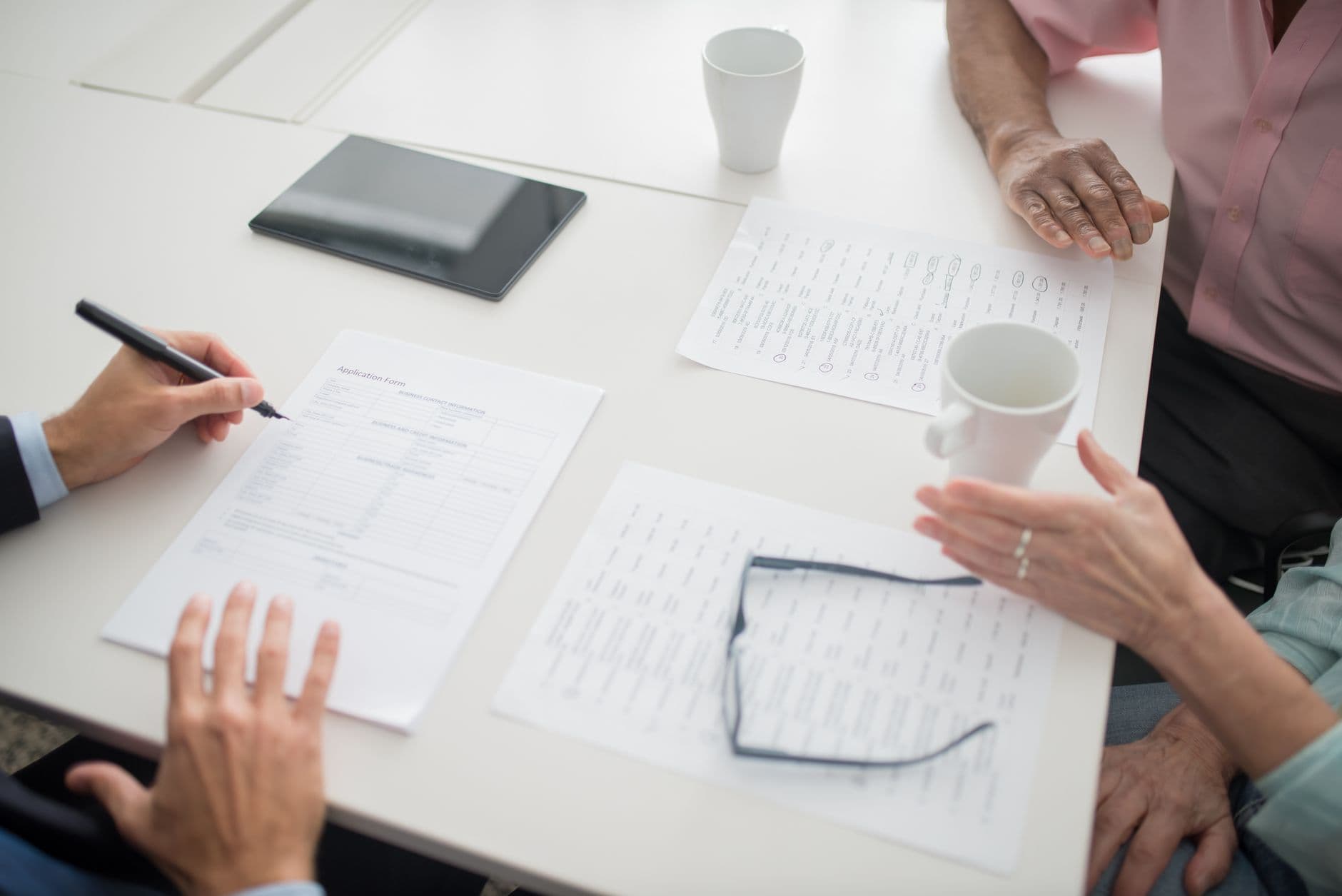 Parents meeting with a teacher at a school conference table