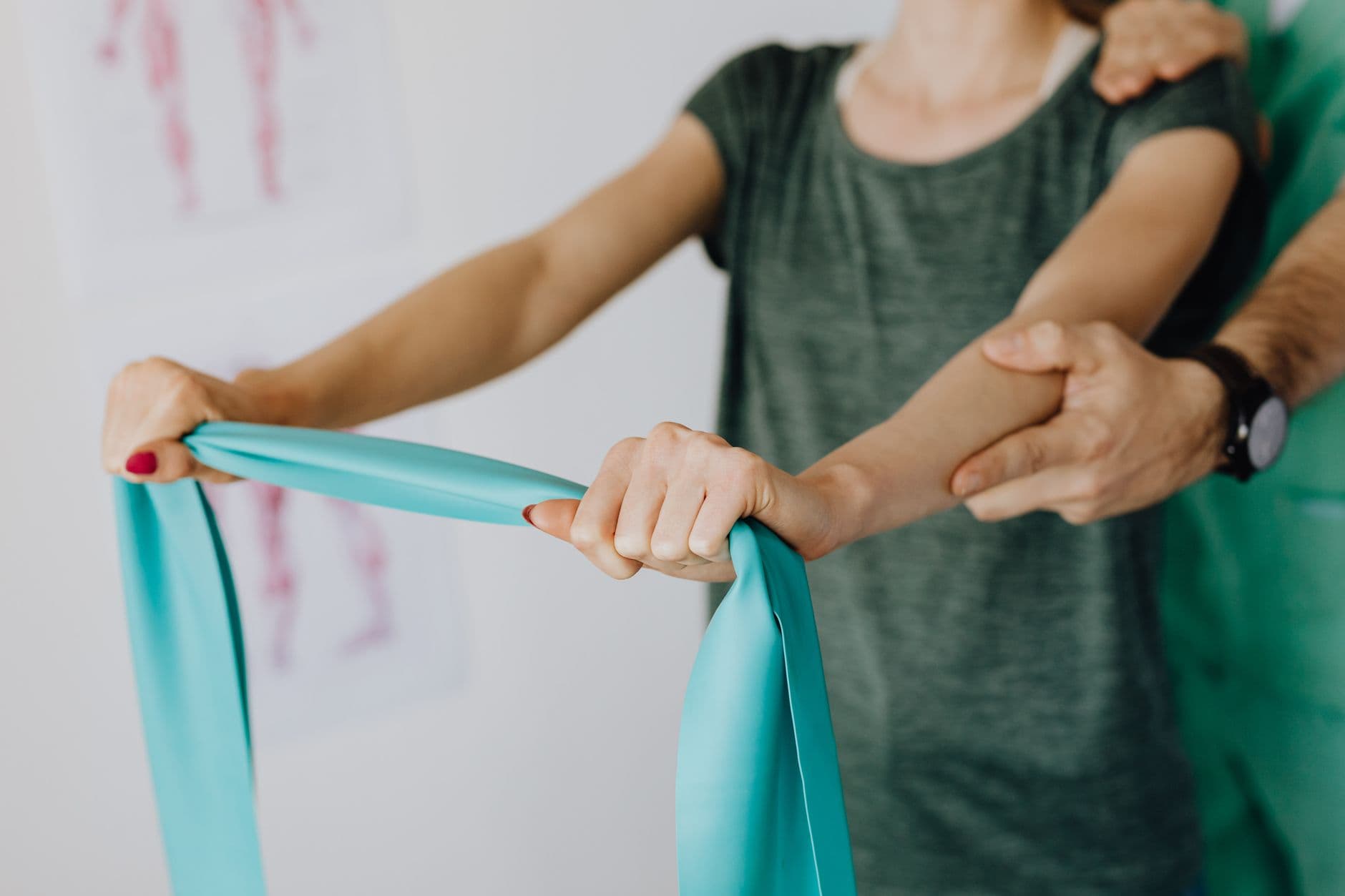 A child playing on a therapy swing while an occupational therapist supports them
