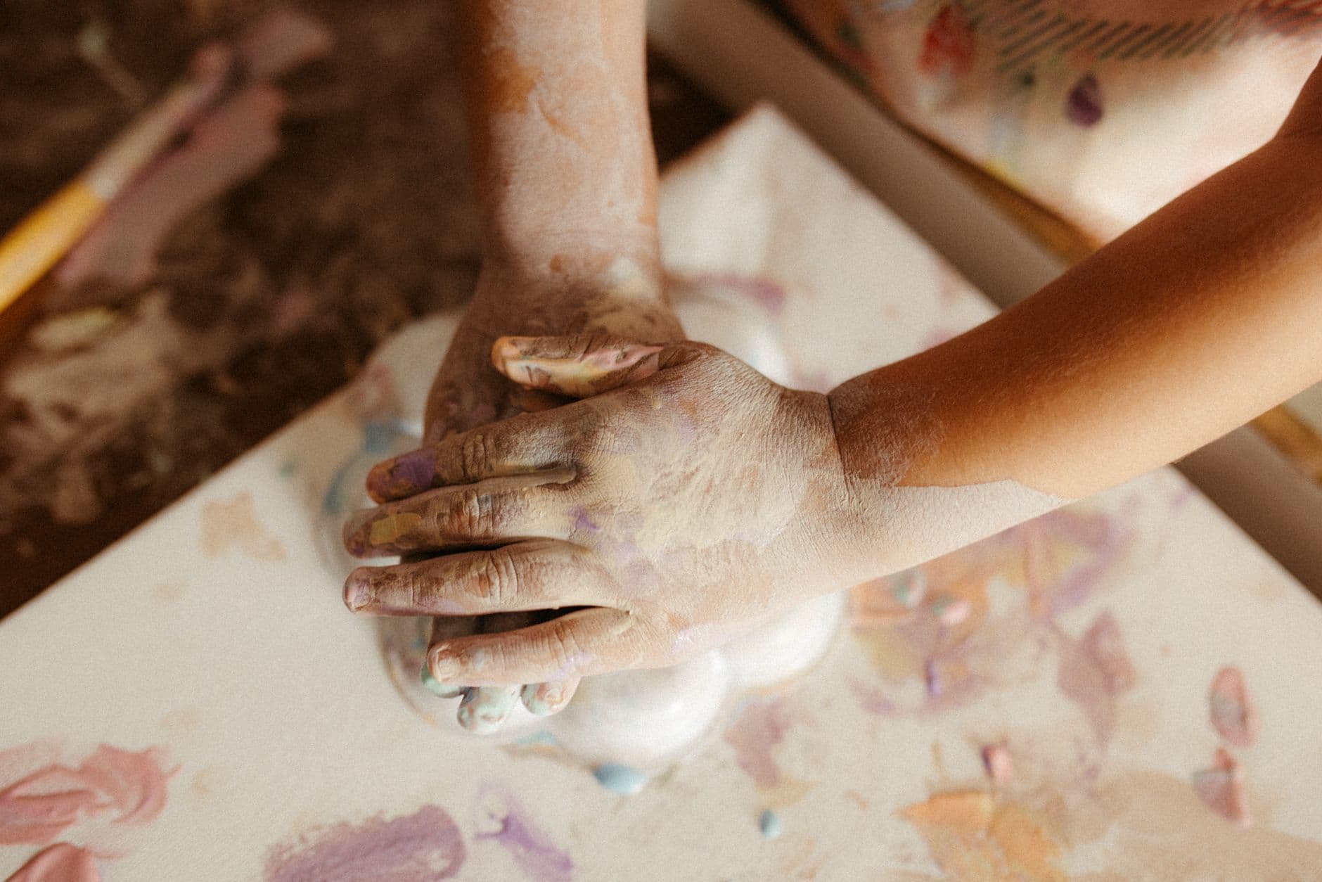 A young child working with colorful therapy putty to build fine motor skills