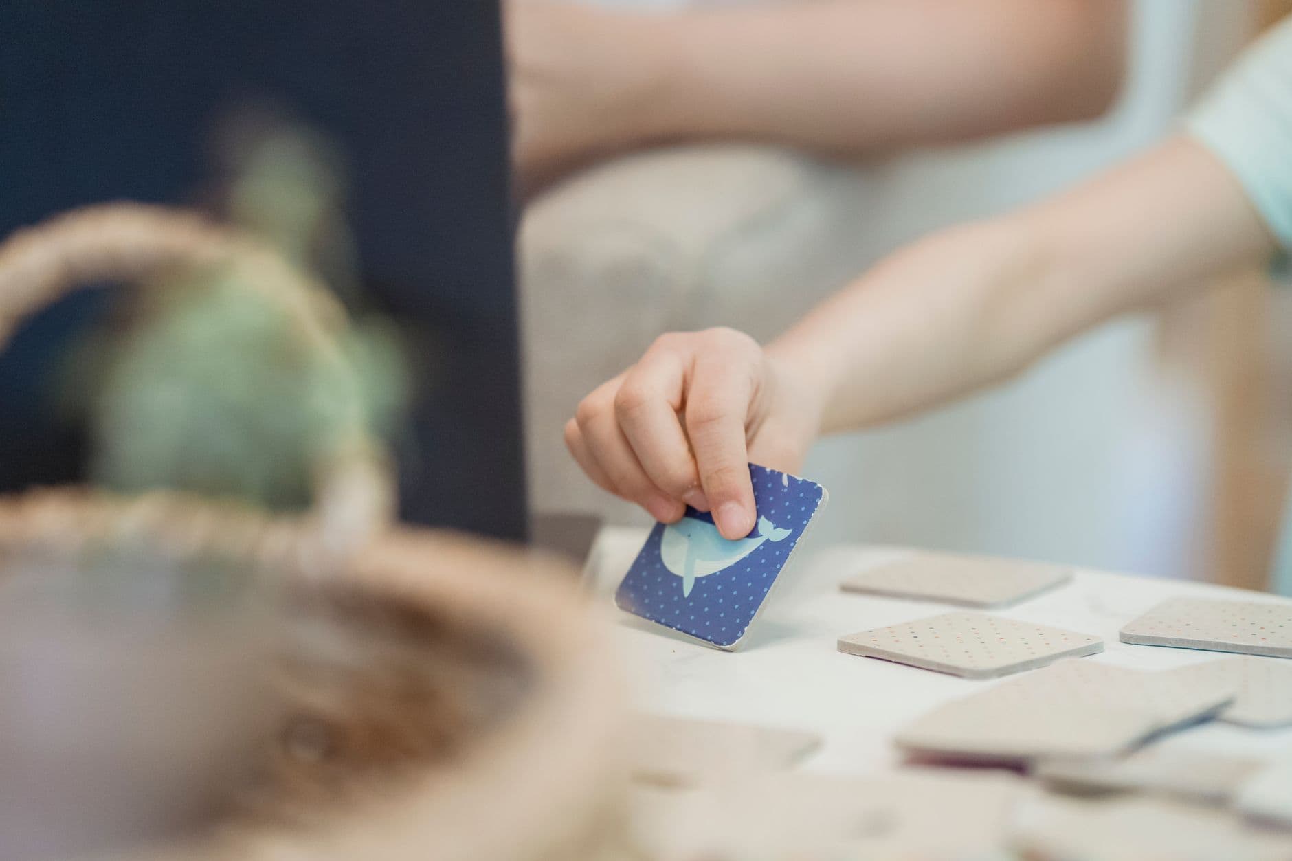 A child pointing at picture communication cards with an adult