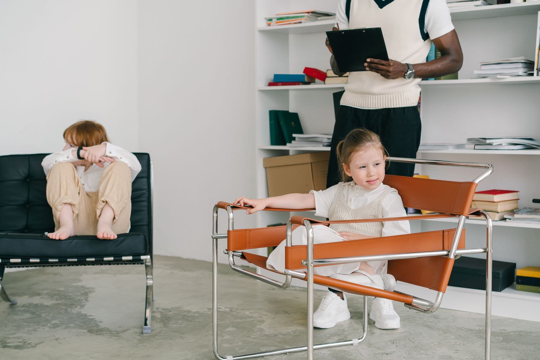 A behavior therapist working one-on-one with a child at a table