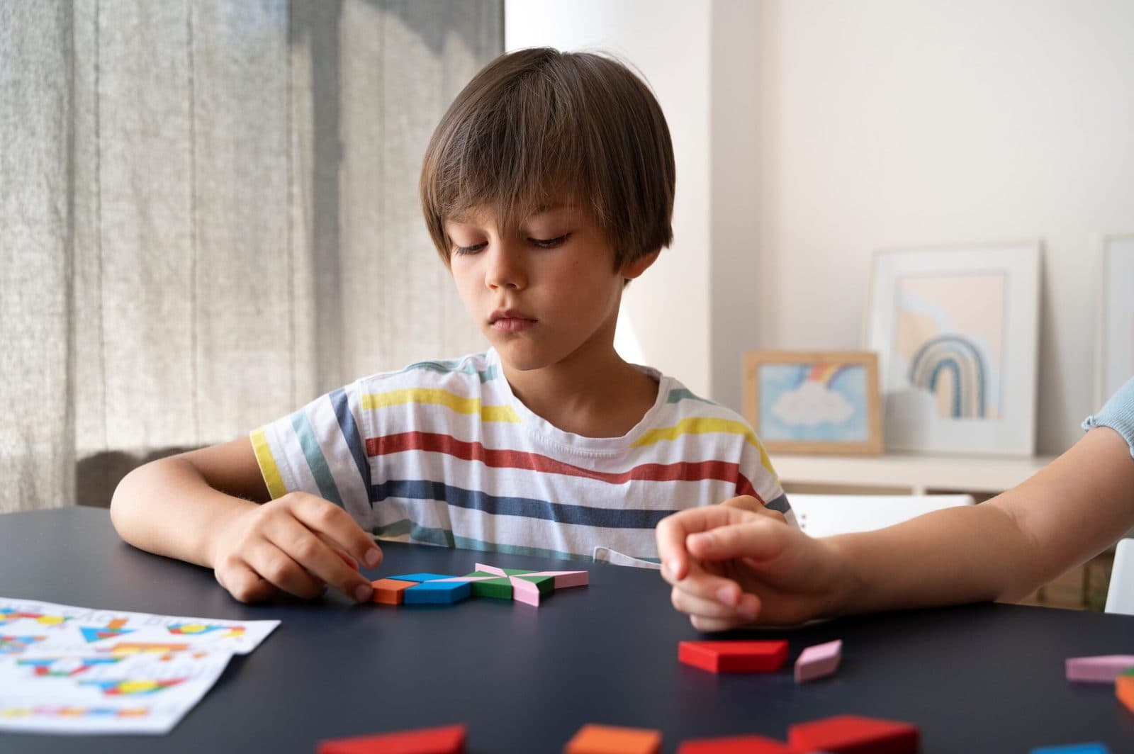 Child working on a puzzle at a table