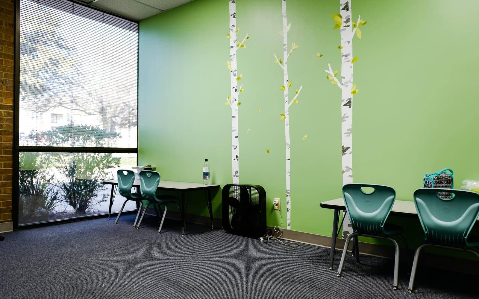 Educational room setup with paired tables and chairs