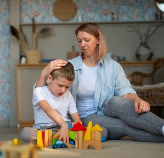 Child playing with blocks during a behavioral therapy session.