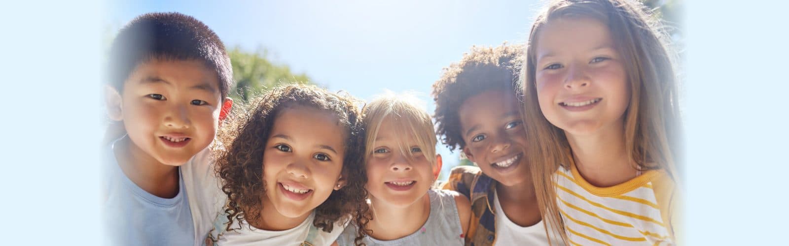 a group of children smiling for a picture