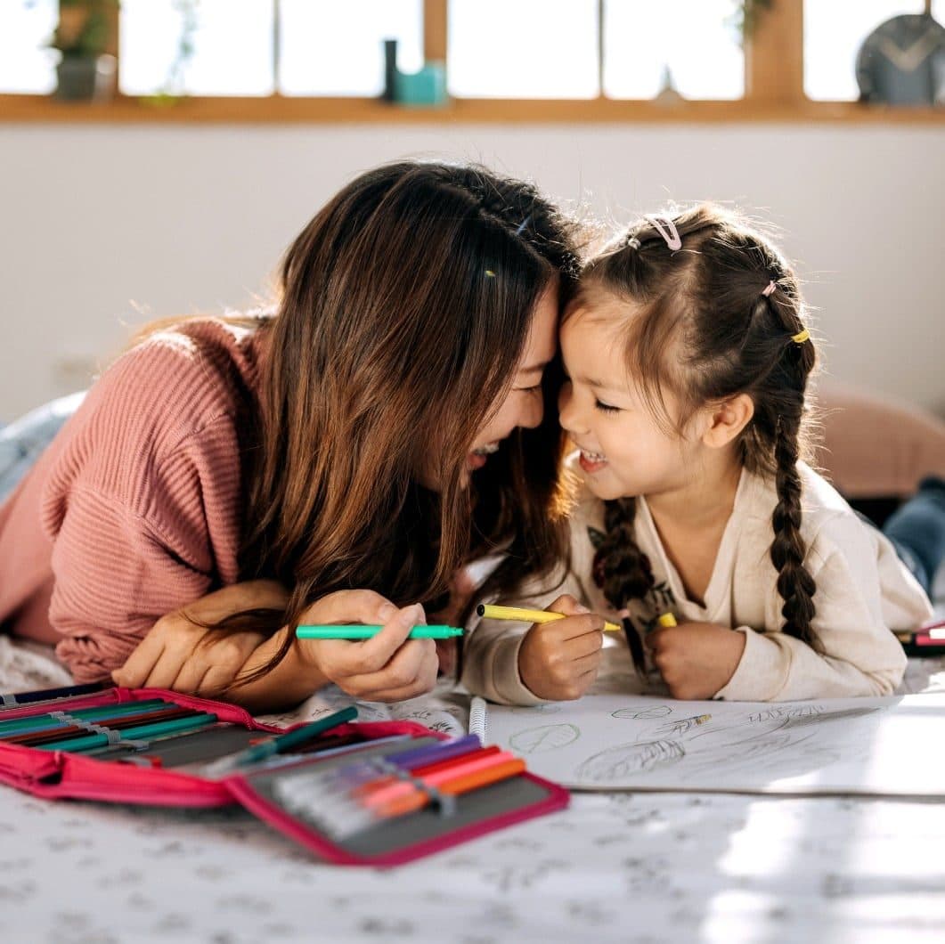 A child smiling with a therapist, highlighting Butterfly Effects impactful approach