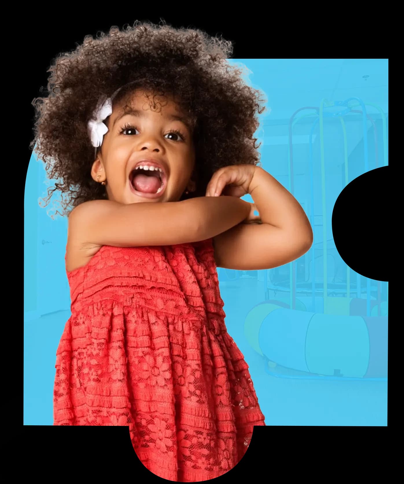 Smiling young girl in red dress flexing arm