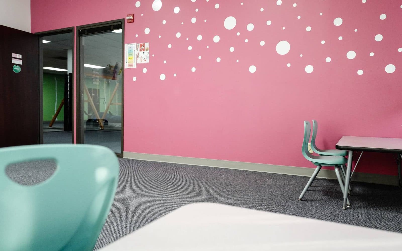 Room with light red accent wall and study table