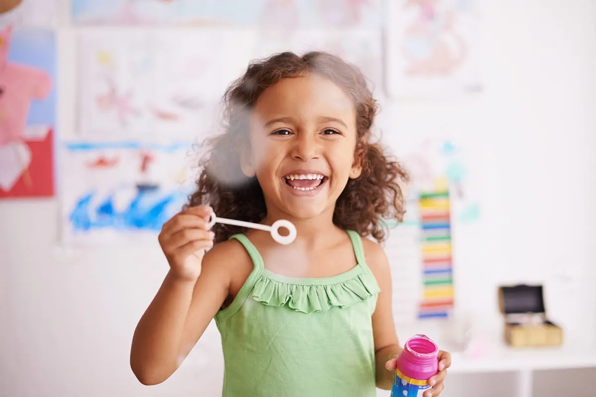 Girl blowing bubbles.