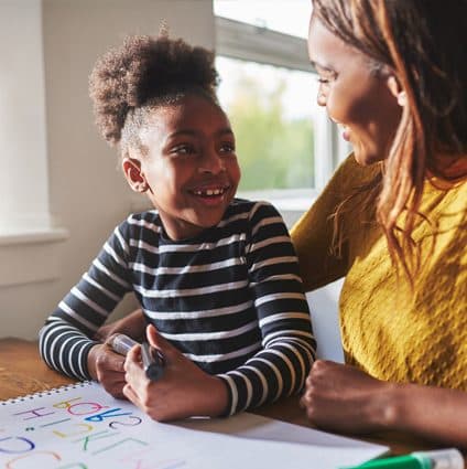 ABA therapist and child writing