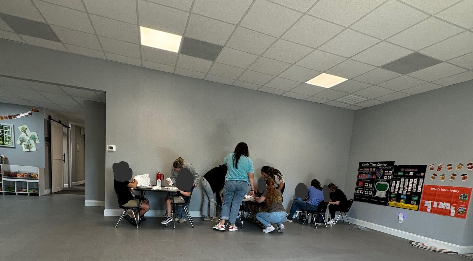 People gathered around a table crafting in a brightly lit room