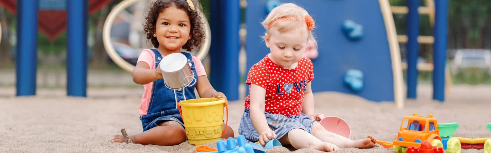 two little girls playing outside