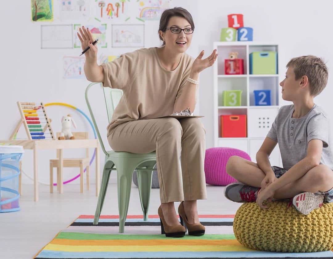 Positive school counselor and pupil sitt