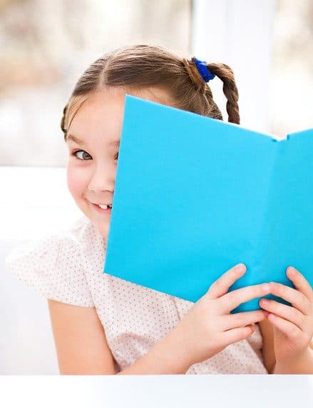 Cute little girl is playing with book.jpg