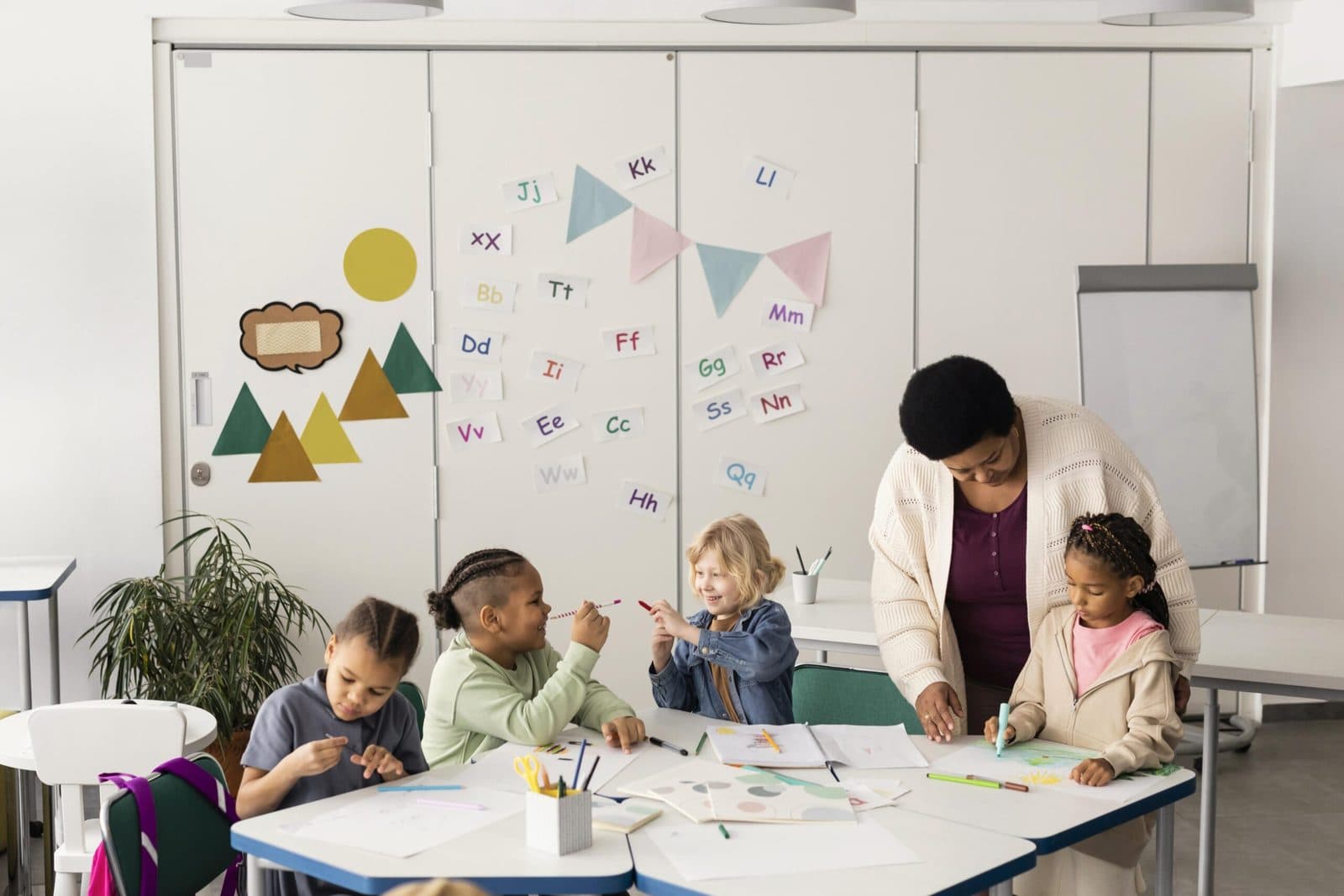 Group of children drawing together in a classroom ABA setting
