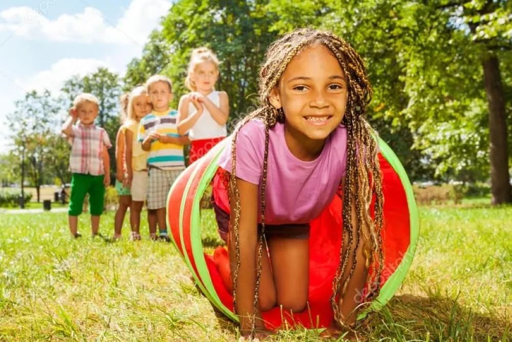 Children having fun crawling a tube