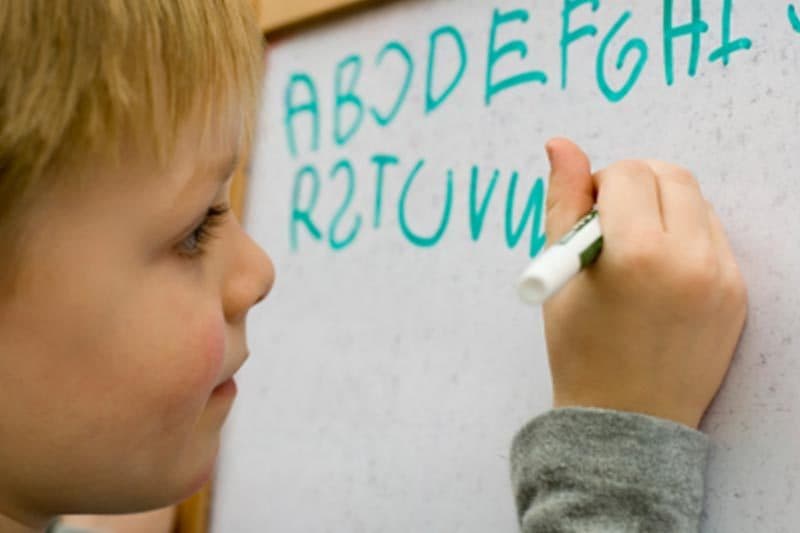 Boy practicing handwriting in an OT session