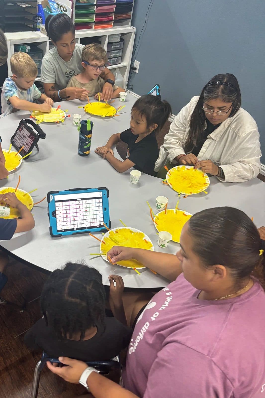 ABA therapy services with children and therapist engaging in group art activities for early intervention, school-age, and adult support