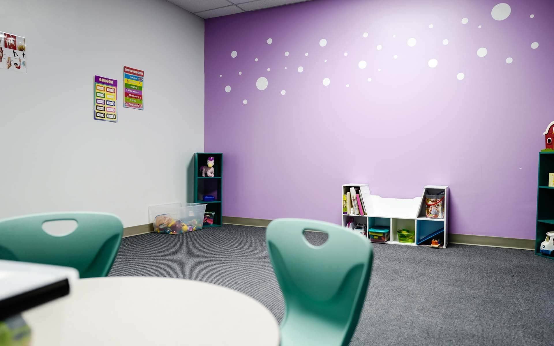 Study room with light purple wall and small shelves