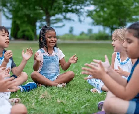 Children doing circle time outside