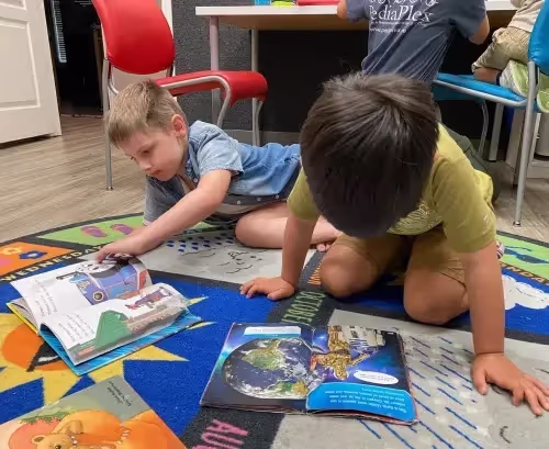 2 kids playing with coloring books at Pediaplex