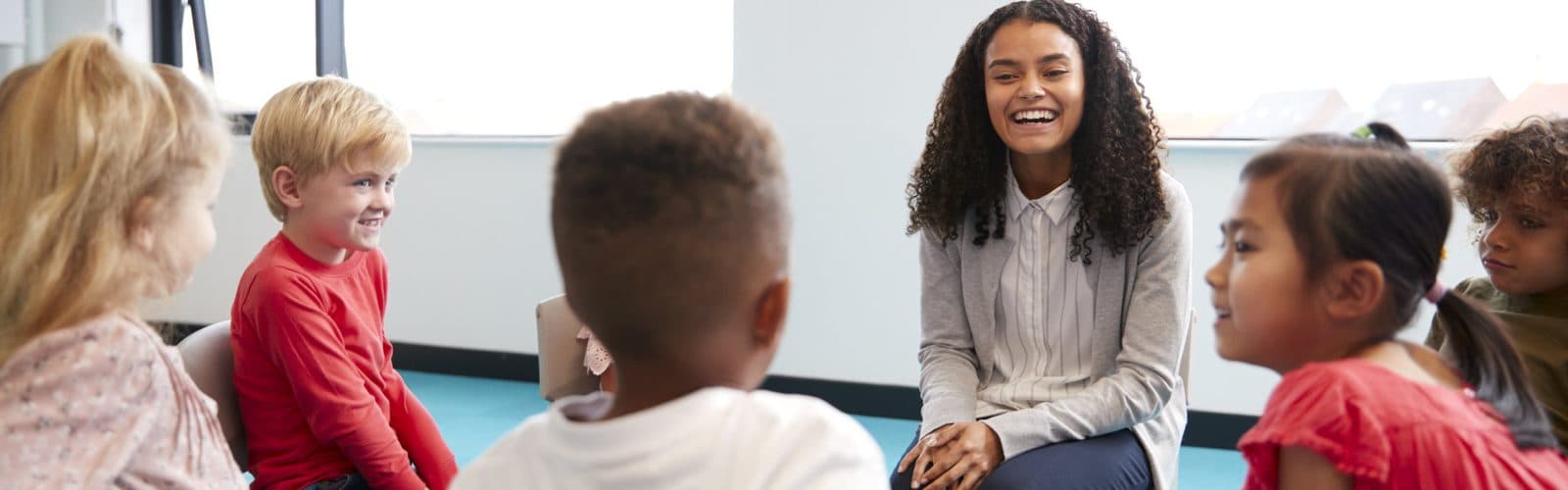 female therapist happily talking to children