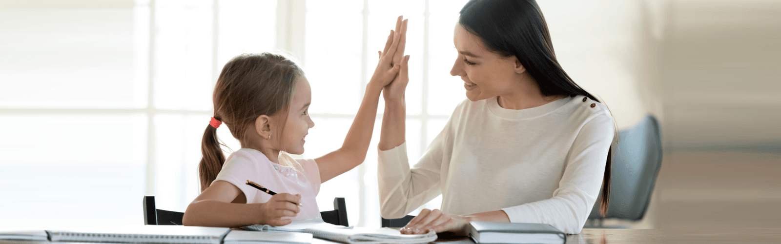 a woman giving high five to a girl