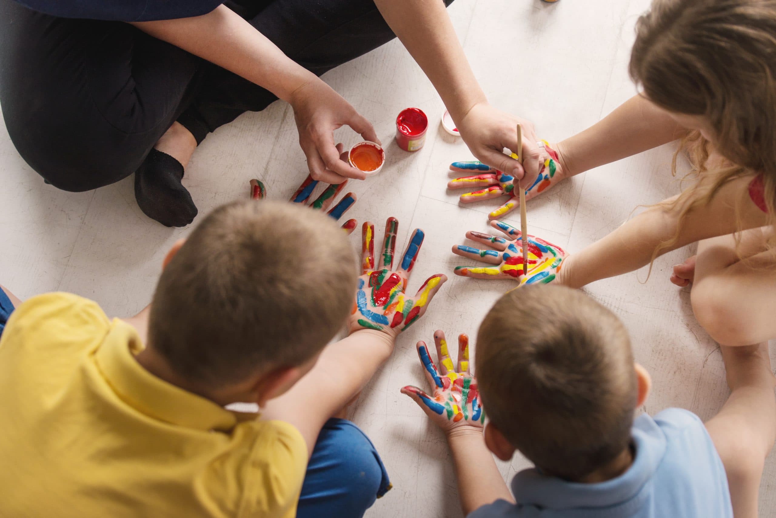 Children doing a group art project at Rise With ABA