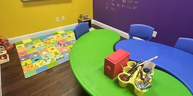ABA therapy room with green and blue table at McKinney TX clinic