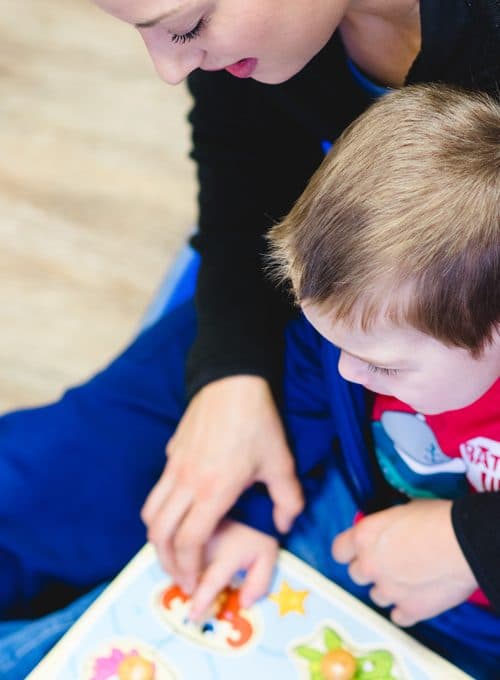 BCBA therapist and child reading